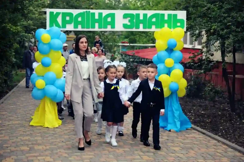 Вчителька зі школярами на першому дзвонику